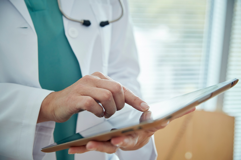 Medical web designers photo of a doctor using a tablet